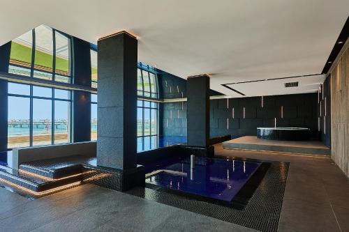a large room with a hot tub in a building at Baltic Infinity Apartments in Międzyzdroje