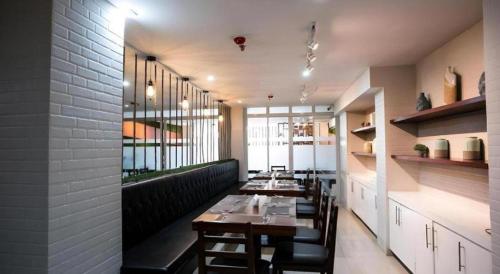 a restaurant with tables and chairs in a room at Hotel Fleur de Liz in Panglao