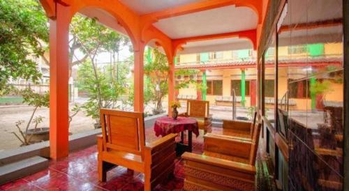 a room with a table and chairs in a building at Super OYO 1788 House 24 in Yogyakarta