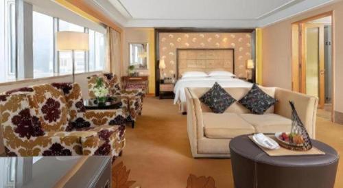 a hotel room with a bed and a couch at Radegast Hotel CBD in Beijing