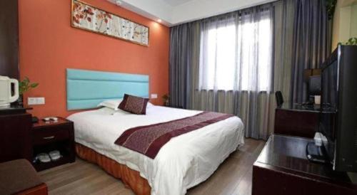 a hotel room with a bed and a television at Hangzhou Bokai Westlake Hotel in Hangzhou
