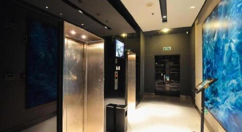 a hallway with an elevator in a building at Jinjiang Inn Luoyang Wangcheng Park Metro Station in Luoyang
