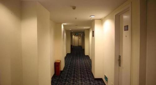 a hallway of an office building with a long corridor at 7 Days Inn Nanjing Xinjiekou Changfu Street Metro Station in Nanjing