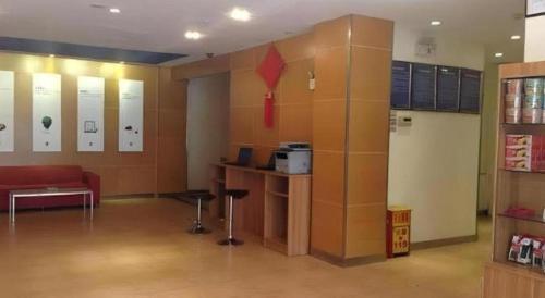 a large room with a red couch in a room at 7 Days Inn Nanjing Xinjiekou Changfu Street Metro Station in Nanjing