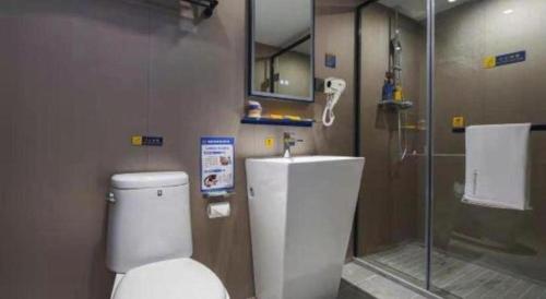 a bathroom with a toilet and a glass shower at 7 Days Inn Nanjing Xinjiekou Changfu Street Metro Station in Nanjing