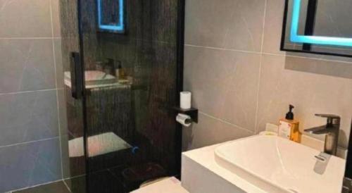 a bathroom with a shower and a sink and a toilet at GreenTree Inn Datong YundinGYAyuan Express Hotel in Datong