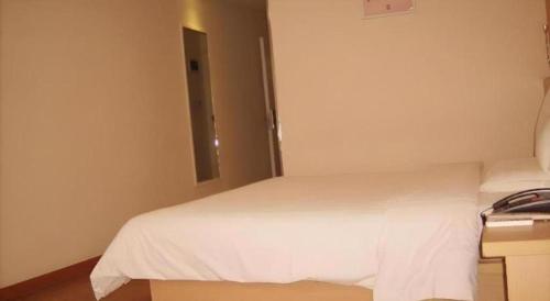 a bedroom with a white bed and a window at 7 Days Inn Changzhou Yancheng Technology Metro Station in Changzhou