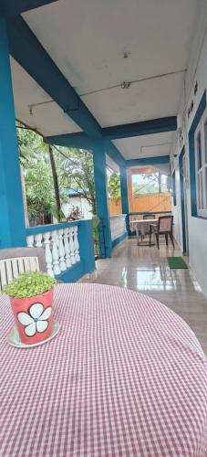 a red and white table with a bowl of greens on it at Chill Beach Abode Hostel in Arambol