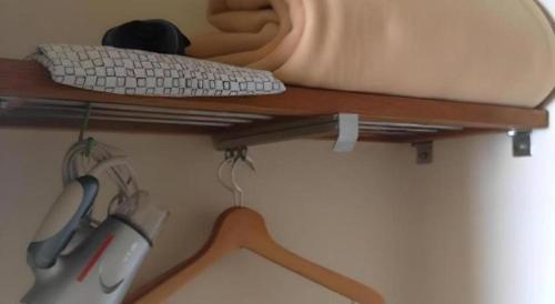a computer keyboard and mouse on a wooden shelf at Marroad Inn Tokyo in Chofu