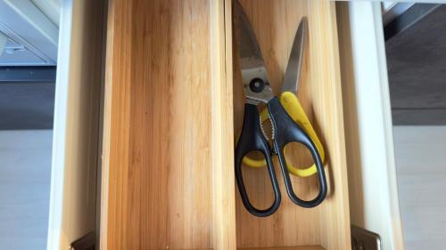 a pair of scissors in a wooden drawer at The SAKAI newly built home 7 mins walk from Train Station in Abiko