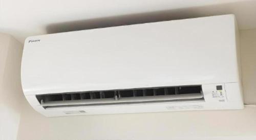 a white microwave oven sitting on top of a wall at KEIKYU EX INN Keikyu Kawasaki-Station in Kawasaki