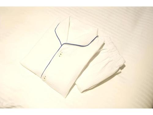 a pile of white pillows on a bed at KEIKYU EX INN Keikyu Kawasaki-Station in Kawasaki