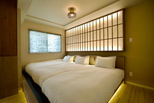 a large bed in a room with a window at Grand Success Kotoni V in Kotoni