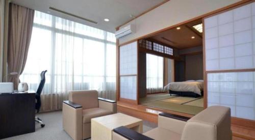 a room with a room with a bed and a mirror at Hamakan Hotel in Unzen
