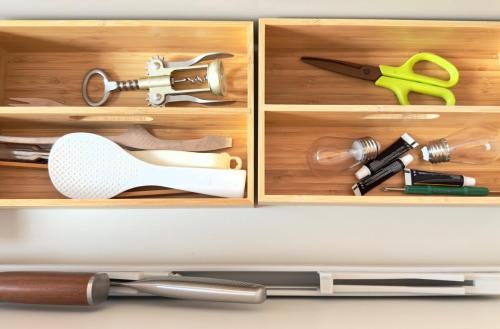 a wooden drawer with a bunch of tools in it at The SAKAI newly built home 7 mins walk from Train Station in Abiko
