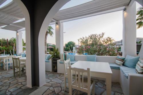 an outdoor patio with a white table and chairs at Olga in Ios Chora