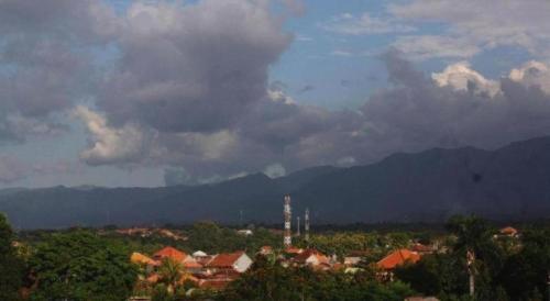 a view of a town with mountains in the background at MANDARI HOTEL SINGARAJA in Ubud