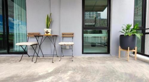 a patio with a table and chairs on a building at Silom Studios in Bangkok