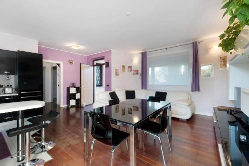 a living room with a glass table and chairs at Dreams To Lake Como in Senna Comasco