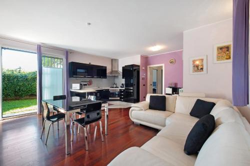 a living room with a white couch and a table at Dreams To Lake Como in Senna Comasco