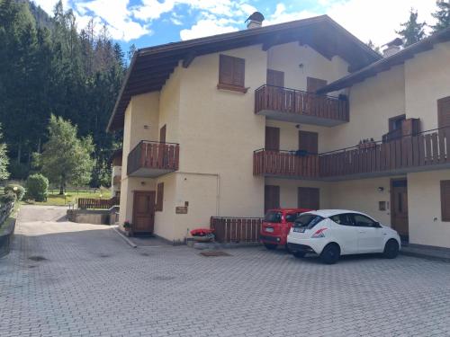 a white car parked in front of a house at Casa Tullia by Go New Location in Ziano di Fiemme