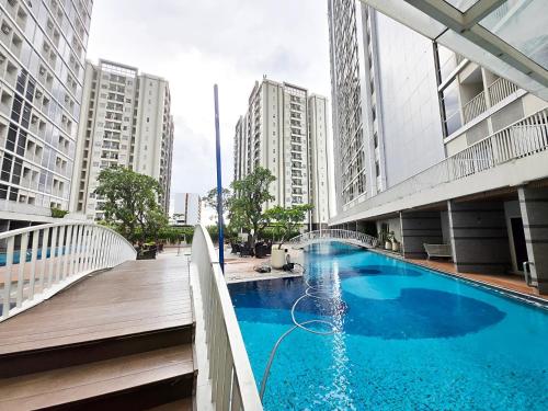 a swimming pool in the middle of a city with tall buildings at Strategic Pacific Gardenia studio Alam Sutra pool and Gym by Luckystay in Warungnangka