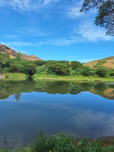 a view of a lake with hills in the background at theoutbackhotel in Tonge