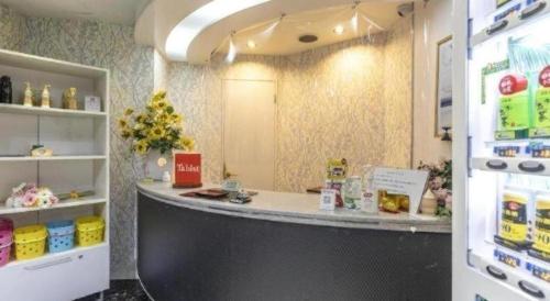 a food counter in a store with a refrigerator at Tabist Hotel Please Kobe in Kobe