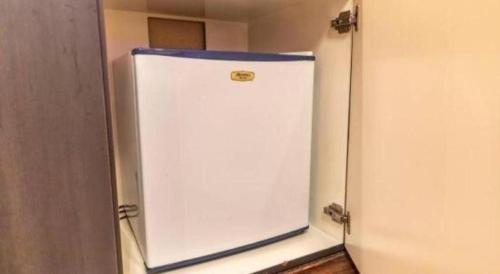 a white refrigerator with a blue top in a room at Tabist Hotel Please Kobe in Kobe