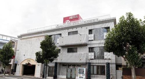 a building with a hotel sign on top of it at Tabist Hotel Please Kobe in Kobe