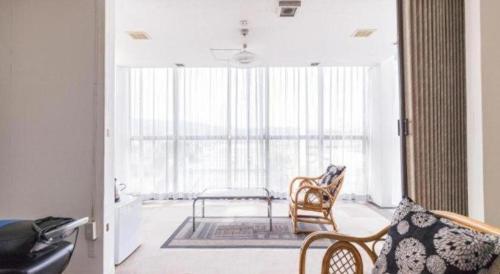 a living room with two chairs and a table at Tabist Joetsu Central Hotel Takada Nakamachi in Joetsu