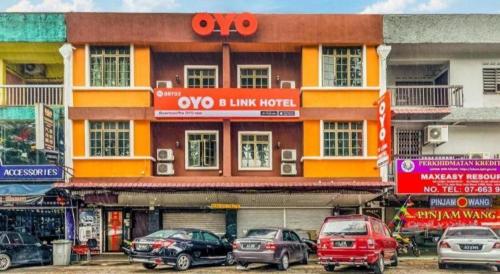 a building with cars parked in front of it at OYO 89703 B Link Hotel in Johor Bahru