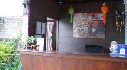 a bar in a restaurant with a picture on the wall at Nan Lanna Hotel in Nan