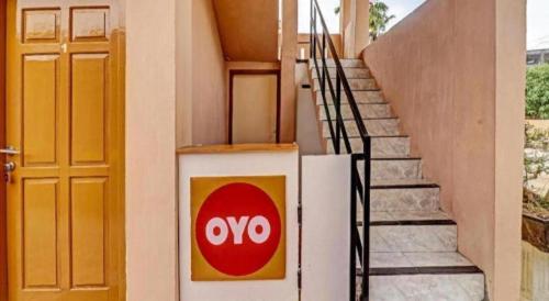 a door to a building with a sign on it at OYO 90945 Arizon Kost in Jambi
