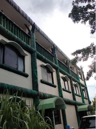 a building with green pipes on the side of it at OYO 800 DDD Habitat Dormtel Bacolod in Bacolod