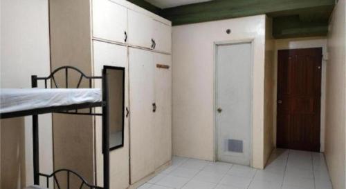 an empty room with a bed and a door at OYO 800 DDD Habitat Dormtel Bacolod in Bacolod