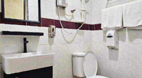 a bathroom with a sink and a toilet at G Six Hotel in Sitiawan