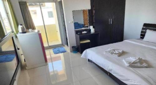 a bedroom with a white bed and a mirror at ONE Residence in Pathum Thani