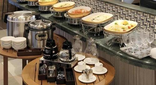a kitchen with a counter with some food on it at Hotel Sunoak Kashiwanoha in Kashiwa