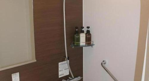 two bottles of wine sitting on a shelf on a refrigerator at Hotel IL FIORE Kasai in Tokyo