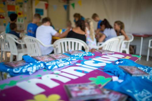 a group of people sitting around a table at Camping Fossalta in Lazise