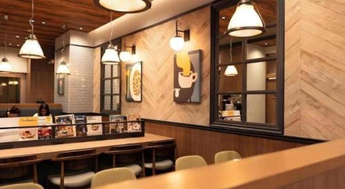 a restaurant with a bar with chairs and a counter at KEIKYU EX INN Tokyo Nihombashi in Tokyo