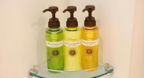 three bottles of liquid sitting on a shelf in a refrigerator at KEIKYU EX INN Tokyo Nihombashi in Tokyo
