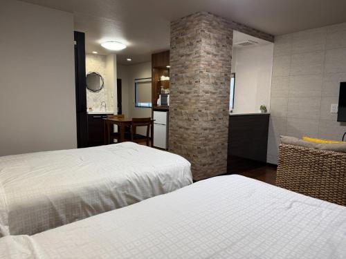 a hotel room with two beds and a kitchen at SA in Nagano Ishido - Vacation STAY 07380v in Nagano