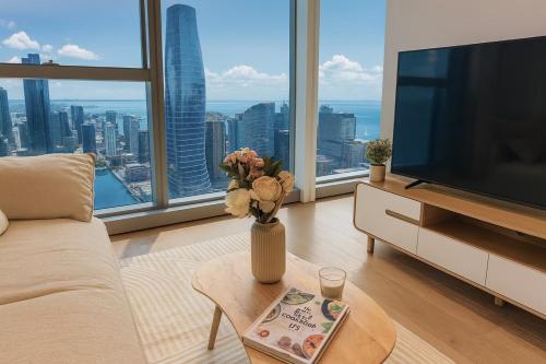 a living room with a television and a vase with flowers at Luxury High-Rise Ocean View Perfect Stay at WSP in Melbourne