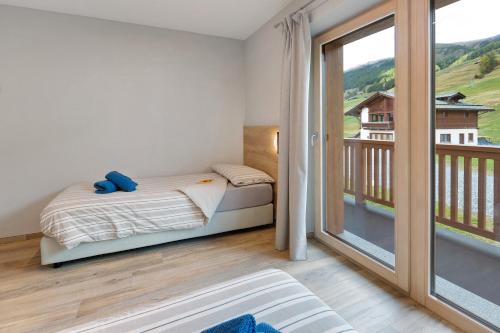 Katil atau katil-katil dalam bilik di Appartamento Sbuffo Livigno