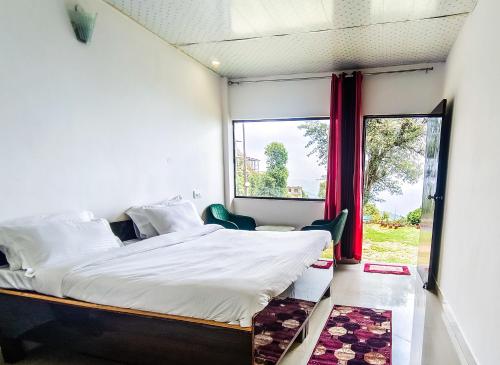 a bedroom with a large bed and a window at King's Paradise Resort by RIHS in Kanatal