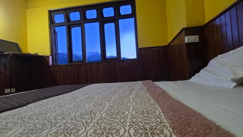 Letto o letti in una camera di Sikkimese Inn Pelling