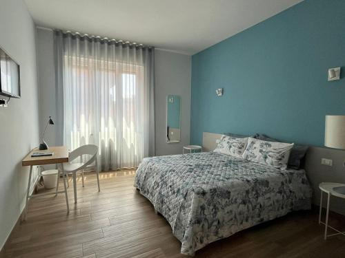 a bedroom with a bed and a table and a desk at Dimora in Fiore B&B in Foggia