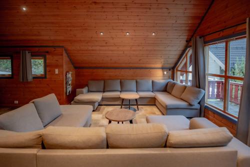 a living room with couches and a table at Bakkebyvegen 7A in Trysil